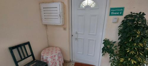 a room with a door and a chair and a plant at Airport Friendly House 4 in Artemida