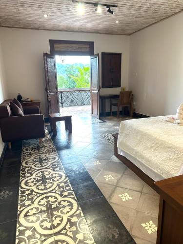 a bedroom with a bed and a chair and a table at Villa Karma Loka in Sidemen
