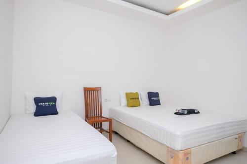 Ένα ή περισσότερα κρεβάτια σε δωμάτιο στο Urbanview Hotel Grand Surya Yogyakarta