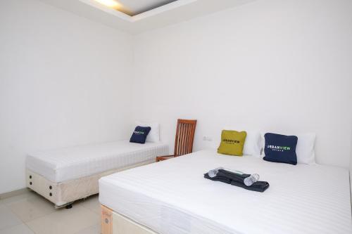 Ένα ή περισσότερα κρεβάτια σε δωμάτιο στο Urbanview Hotel Grand Surya Yogyakarta