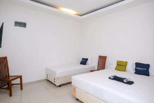 Ένα ή περισσότερα κρεβάτια σε δωμάτιο στο Urbanview Hotel Grand Surya Yogyakarta