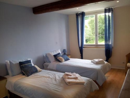 two beds in a room with a window at Domaine de Polf,ages - just for you and your family in Villautou