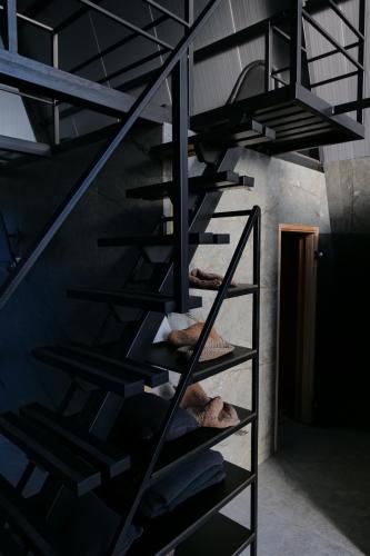 a black spiral staircase in a dark room at Green Village Pensiune in Roşu