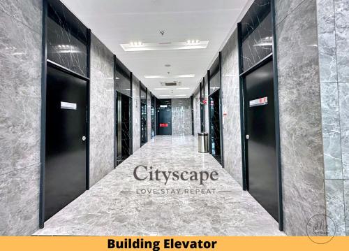 a corridor of a building elevator with black doors at Alinea Suites Shah Alam Seksyen 14 by Cityscape in Shah Alam