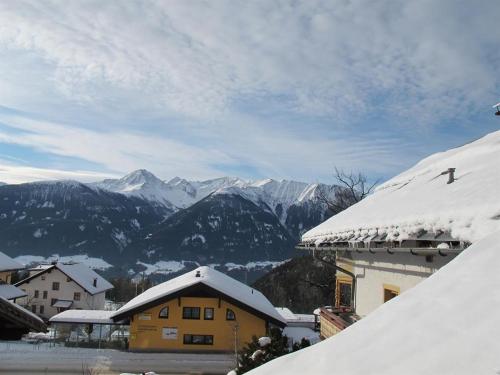 a snow covered village with mountains in the background at Hauspircher in Reith bei Seefeld