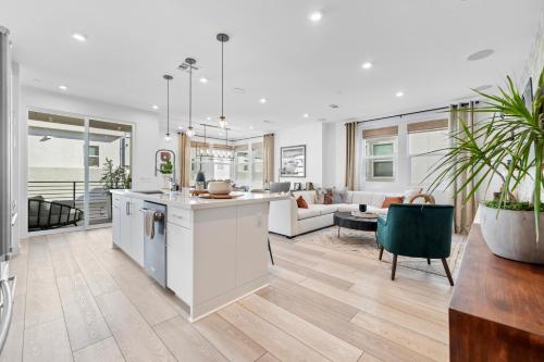 an open kitchen and living room with a couch at #Marbella Lane-Luxury Designer 3BR Home Disneyland in Anaheim