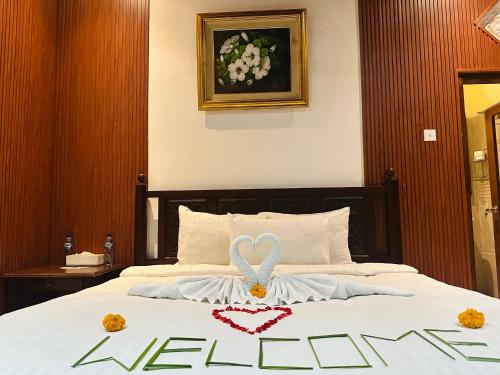 a bedroom with a bed with a heart decoration on it at Puri Jumpungan Villas in Sidemen