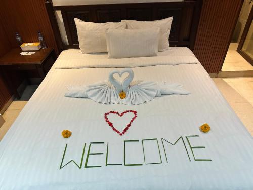 a bed with a welcome sign on top of it at Puri Jumpungan Villas in Sidemen