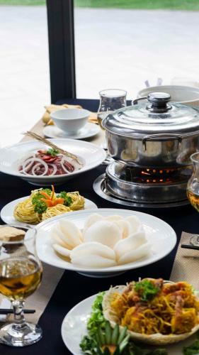 a table with plates of food and a grill at Seaside Boutique Resort Quy Nhon in Quy Nhon