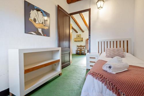a small bedroom with a bed and a mirror at Ca La Maria in Santes Creus