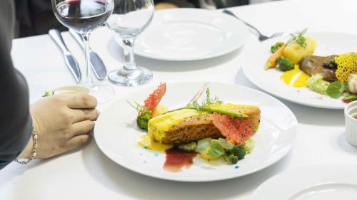 a table with plates of food and glasses of wine at Seaside Boutique Resort Quy Nhon in Quy Nhon