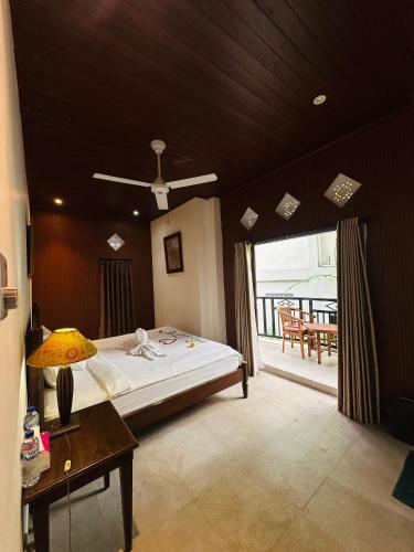 a bedroom with a large bed and a balcony at Puri Jumpungan Villas in Sidemen