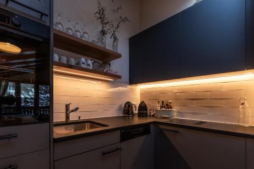 a kitchen with a sink and a counter top at Dachwohnung Balma-great overview of Zermatt in Zermatt