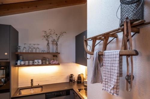 a kitchen with a sink and a towel hanging on the wall at Dachwohnung Balma-great overview of Zermatt in Zermatt