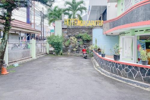 a scooter parked in front of a building at Urbanview Hotel Dasa Putra Syariah Sumedang in Parakankondang