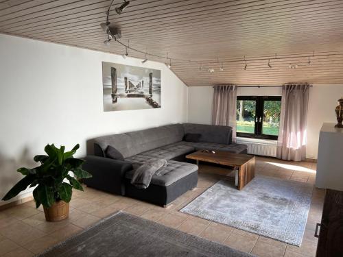 a living room with a couch and a table at WohlfühlQuartier Schwedenstein in Bad Oeynhausen