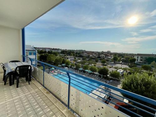 a balcony with a table and chairs and a view of a city at Lovely flat overlooking the pool in Veneto