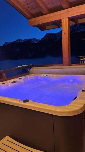 a hot tub on the deck of a boat at Loft de luxe en attique avec vues panoramiques in Vionnaz