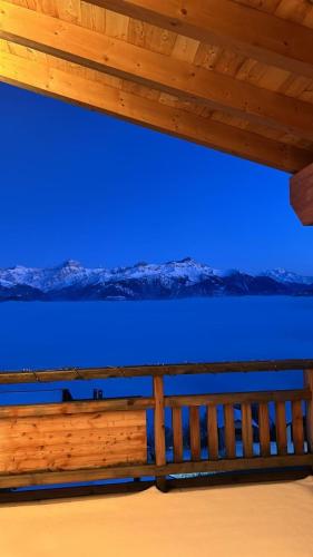 a wooden fence with a blue sky in the background at Loft de luxe en attique avec vues panoramiques in Vionnaz