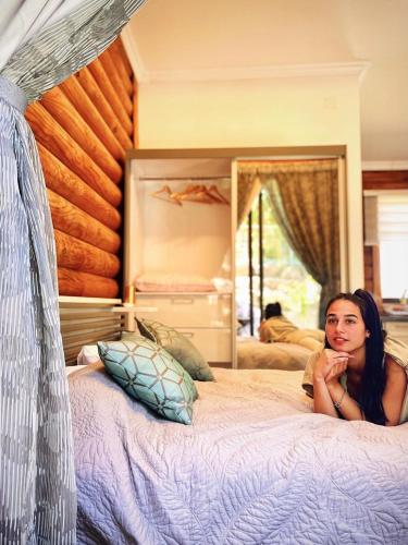 a woman laying on a bed in a bedroom at גן הדובדבנים in Odem