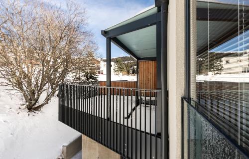 a balcony of a house with snow on the ground at Arton Lachtal - Apartments Steiermark in Lachtal