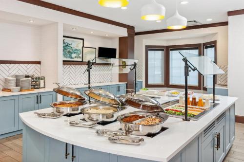 a kitchen with a buffet of food on a counter at Staybridge Suites Albany Wolf Rd-Colonie Center by IHG in Albany
