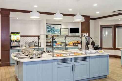 a kitchen with blue cabinets and a counter top at Staybridge Suites Albany Wolf Rd-Colonie Center by IHG in Albany
