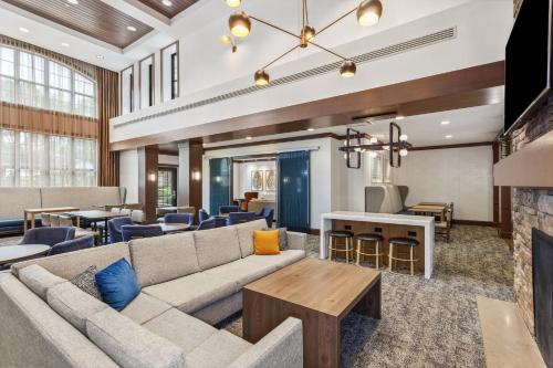 a living room with a couch and a table at Staybridge Suites Albany Wolf Rd-Colonie Center by IHG in Albany