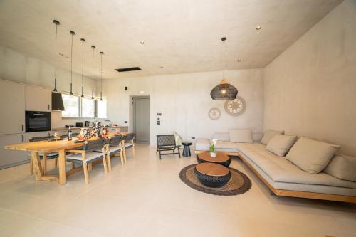 a living room with a couch and a table at Lithos Art Villas in Sarlata
