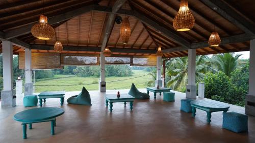a pavilion with tables and benches and lights at OMA Hikkaduwa in Hikkaduwa