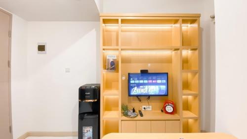 a room with a partition with a tv in it at PIK 2 Tokyo Riverside 2 BEDROOM in Gedong