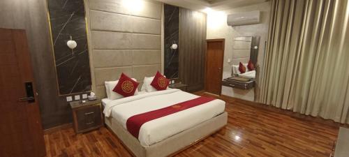 a bedroom with a large bed and a large mirror at Ambassador Suite 1 in Dargai