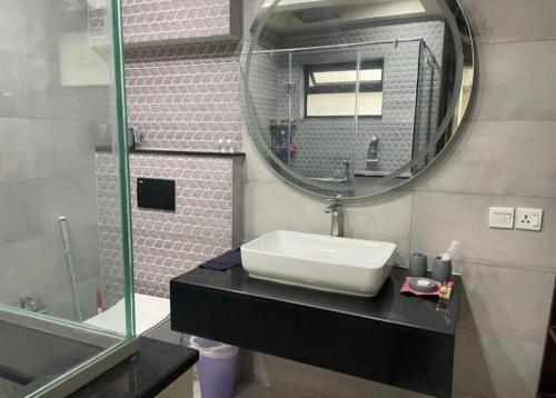 a bathroom with a sink and a mirror at Royal Villa's DHA in Lahore