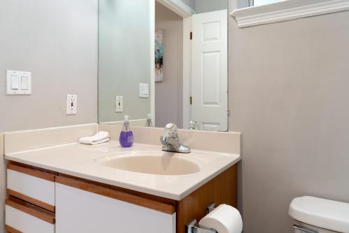 a bathroom with a sink and a mirror at Bright Quiet Comfy 1BR Cottage in Mountain View in Mountain View