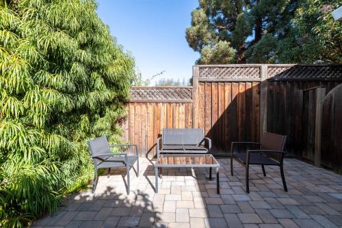 a patio with a table and two chairs and a fence at Bright Quiet Comfy 1BR Cottage in Mountain View in Mountain View
