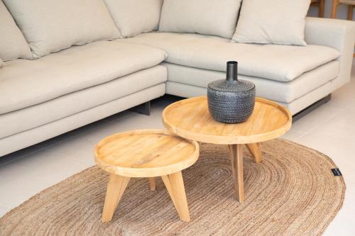 a living room with two tables and a couch at Lithos Art Villas in Sarlata
