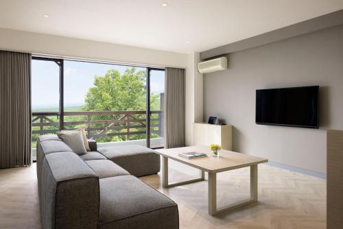 a living room with a couch and a table at Hotel Laforet Nasu in Nasu