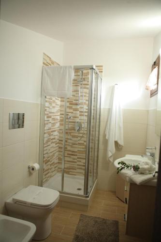 a bathroom with a shower and a toilet and a sink at Bono Vacanze Villa San Marco Luxury Holidays Homes in Sciacca