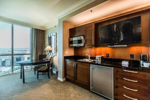 a kitchen with a sink and a desk in a room at Strip View Sub-Penthouse 34709 in Las Vegas