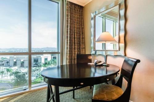 a room with a table with a lamp and a window at Strip View Sub-Penthouse 34709 in Las Vegas