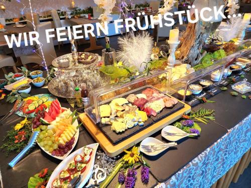 a buffet of food on a table with food on it at Altstadt Pension Orchidee in Wernigerode