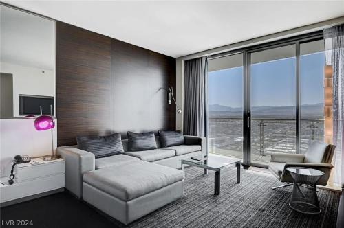 a living room with a couch and a large window at Beautiful Mountain View Palms Studio 30307 in Las Vegas