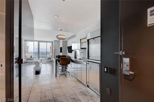 a room with a kitchen with a table and a counter at Beautiful Mountain View Palms Studio 30307 in Las Vegas
