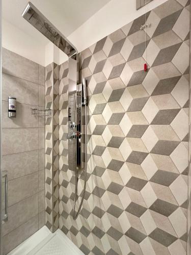 a bathroom with a shower with a tiled wall at BB Nuova Villa Paradiso in Urbino