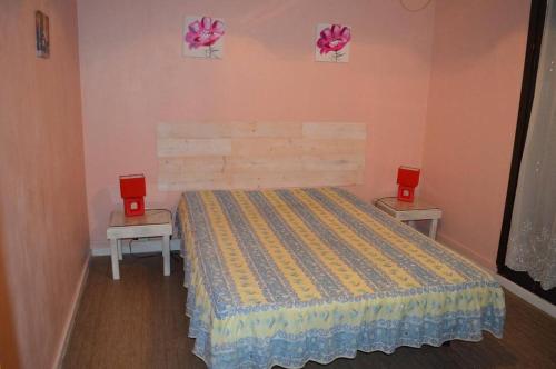 - une chambre avec un lit avec deux tables et deux haut-parleurs rouges dans l'établissement Appart 3 pièces 6 couchages BANYULS SUR MER BN020-036, à Banyuls-sur-Mer