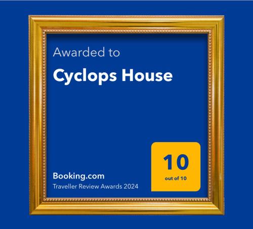 a gold picture frame with the words upgraded to cyclops house at Cyclops House in Serifos Chora