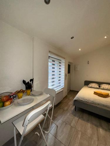 une chambre avec un lit, une table et des chaises dans l'établissement # Le 6 # Joli petit studio ! Centre ville au calme, à Mulhouse