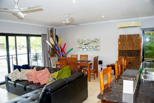 a living room with a couch and a dining room at Bungalow 25 at Lake Bennett in Lake Bennett