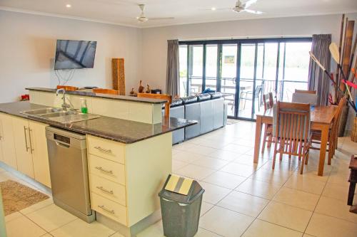 a kitchen with a counter and a table with chairs at Bungalow 25 at Lake Bennett in Lake Bennett