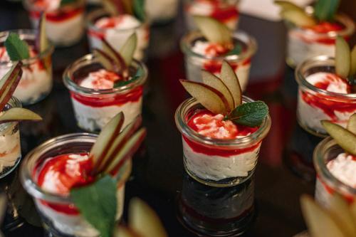 a table topped with mason jars filled with desserts at Ramada by Wyndham Essen in Essen